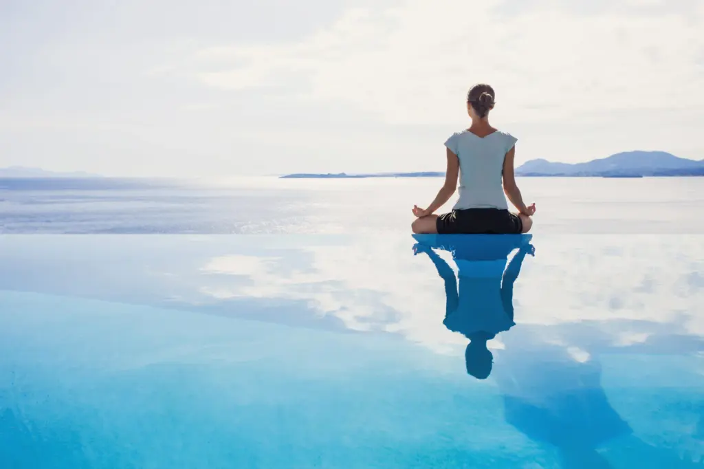 Woman sitting in a beautiful calm place doing meditation in Salt Lake City, UT | Santosh Yoga Institute