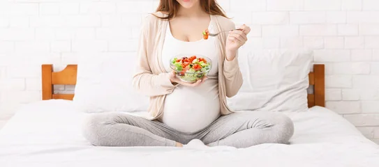 Pregnant woman eating healthy food in Salt Lake City, UT | Santosh Yoga Institute