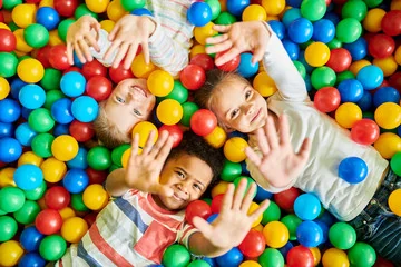 Cute kids lying on balls showing their hands in Salt Lake City, UT | Santosh Yoga Institute