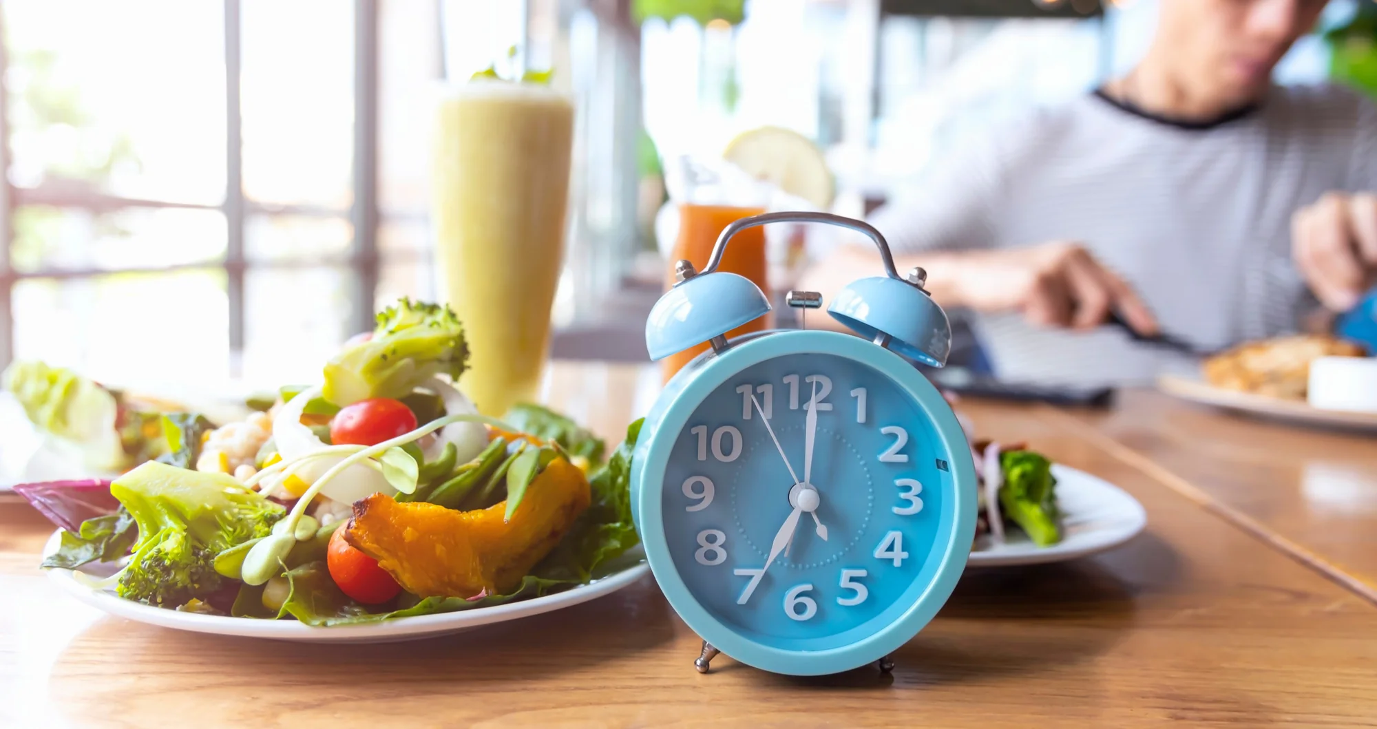 Food and alarm clock on the table in Salt Lake City, UT | Santosh Yoga Institute