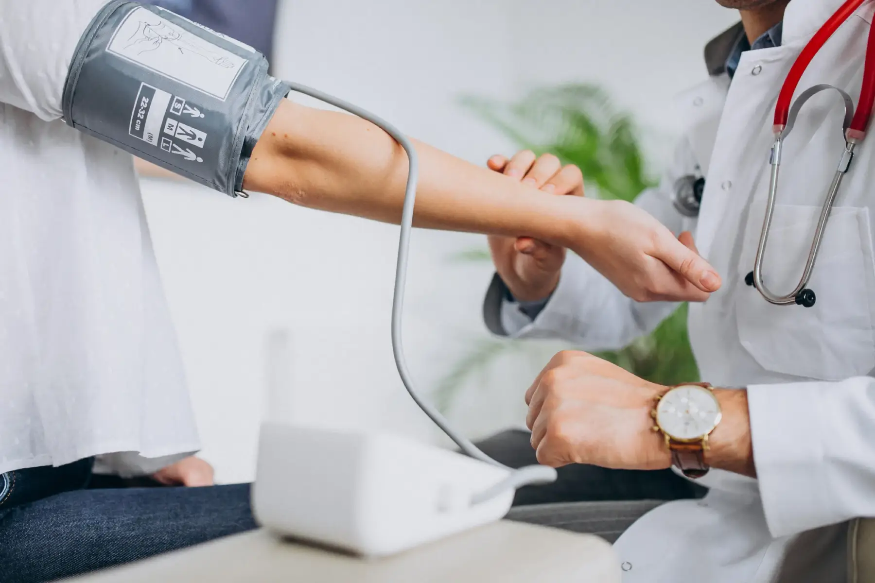 Doctor Checking Patient Blood-Pressure in Salt Lake City, UT | Santosh Yoga Institute